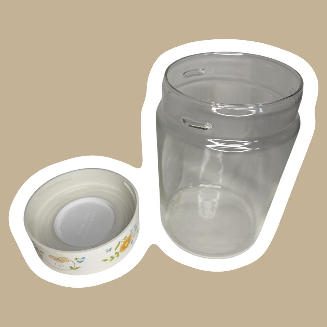 Bote de vidrio con tapa y diseño floral de la década de 1970 de Corning Pyrex con diseño de flores silvestres